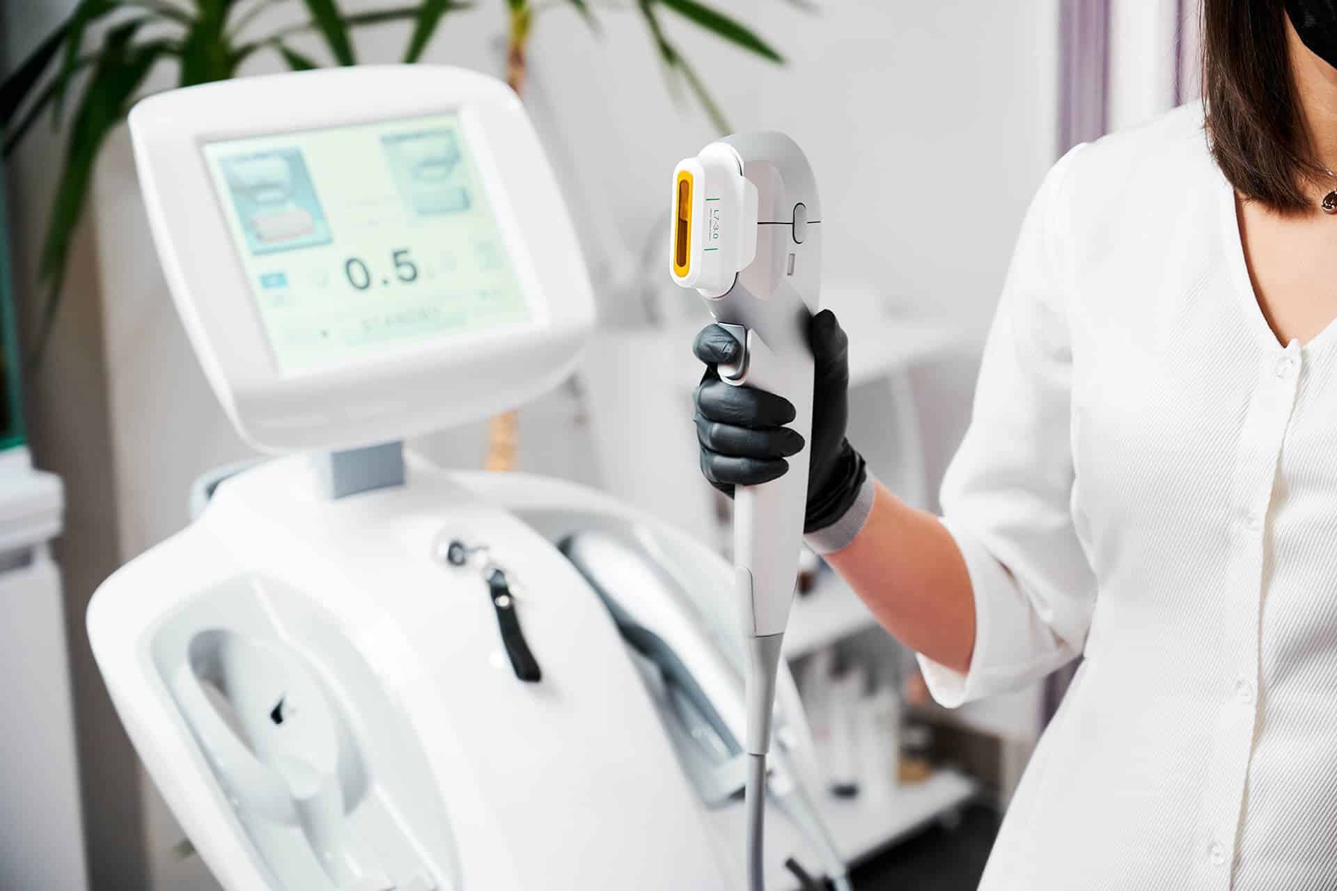 dermatologist in Bensalem holding a cosmetic laser