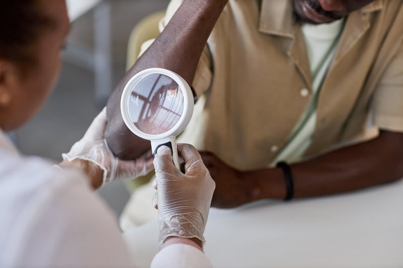 dermatologist examining a patient